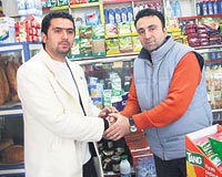 Blent Karacan (solda) 100 karton sigara ald market sahibi Mustafa Akkayaya borcunu derken duygulu anlar yaand.