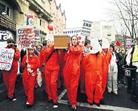 CONDI, BUGN KA OCUK LDRDN? ... Blackburndeki gstericiler, Bakan Rice protesto ederken Guantanamodaki terr esirlerine gnderme yaparak turuncu tulumlar giydi.